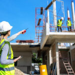 The engineer talks to the contractor to supervise and plan the work.